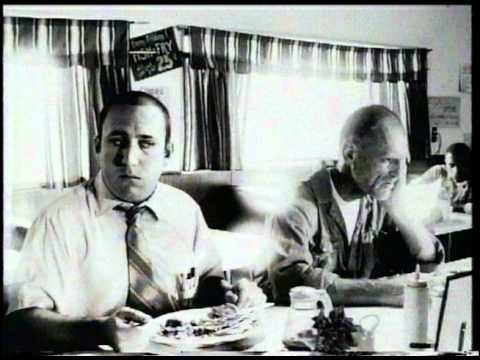 Two men at a diner table, in black and white: possibly “Drysville Cafe” (not confirmed)