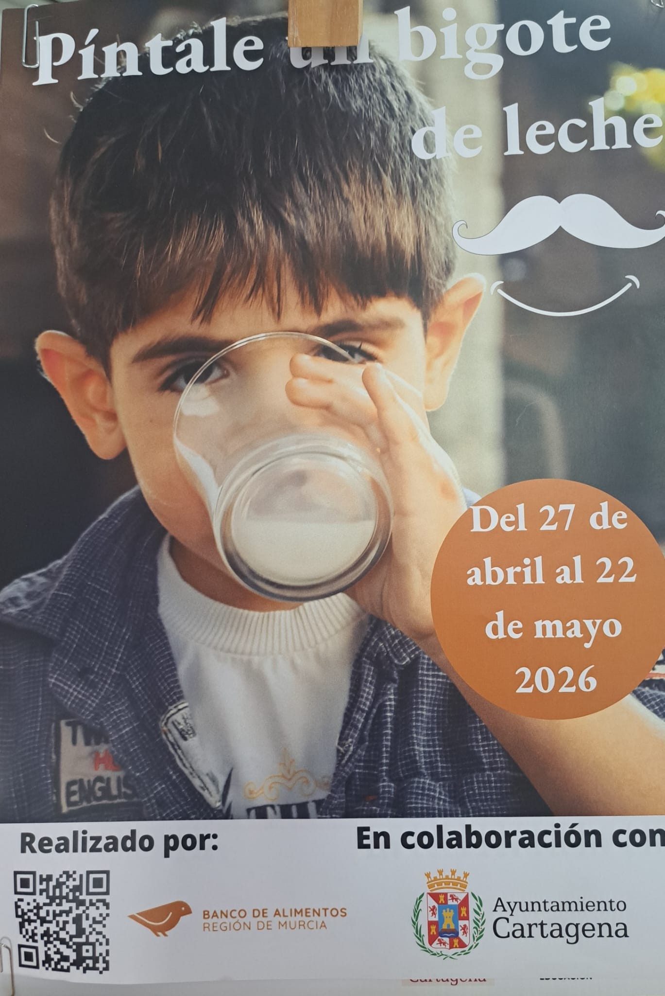 “Píntale un bigote de leche” — food-bank milk drive poster (Cartagena, Spain)